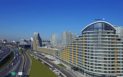 unique-residential-project-with-commercial-stores-under-it-next-to-main-roads-and-parked-cars-next-to-green-areas