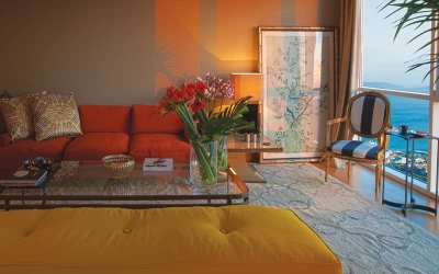 interior-view-of-the-genuinely-designed-living-room-including-two-couches-as-yellow-and-orange-and-having-glamorous-sea-view