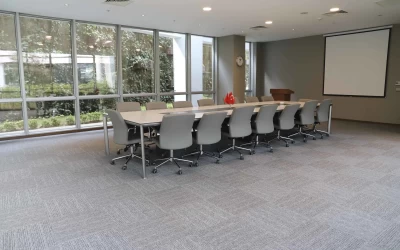 interior-view-of-spacious-meeting-room-including-a-rectangular-table-white-board-and-sixteen-chairs
